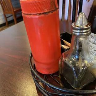 Dirty condiments bottle at my table