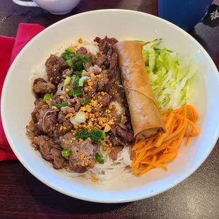 The vermicelli noodle bowl with egg roll.