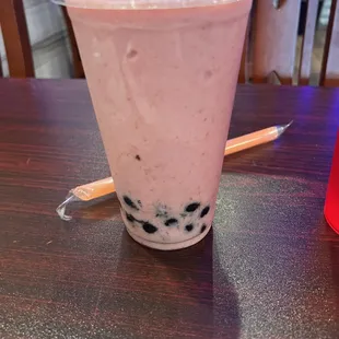 a drink in a plastic cup on a table