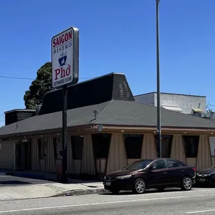 two cars parked in front of a restaurant