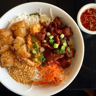 noodle dish with eggroll, shrimp, and grilled pork
