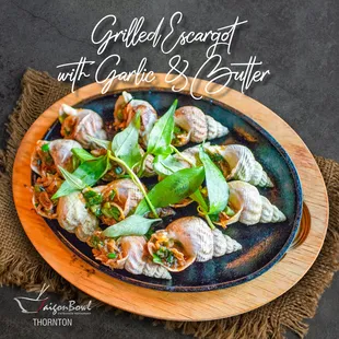 a plate of snails with garlic and butter