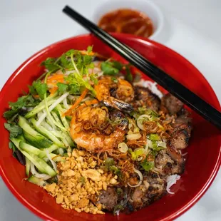 a bowl of food with chopsticks