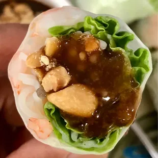 a hand holding a wrap of food