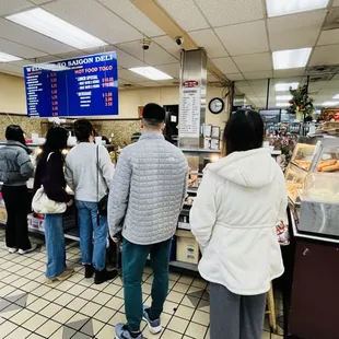 people waiting in line to order food