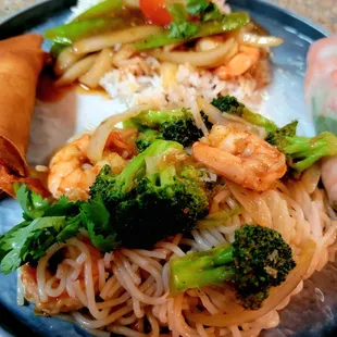 a plate of noodles, shrimp, and vegetables