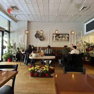 people sitting at tables in a restaurant