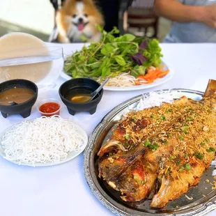 Cá Quay Dừa Xiêm Da Giòn Kiêu Bên Tre: Signature Crispy Roasted Whole Catfish, w/ rice paper, vermicelli, herbs | M-$53, L-$60