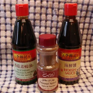 three bottles of sauce on a checkered cloth