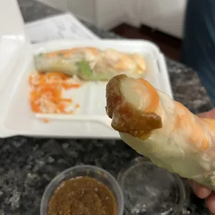 a hand holding a piece of food
