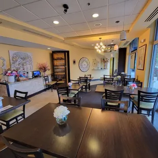 The restrooms are located straight ahead through the doorway in the back where the walls taper inwards.