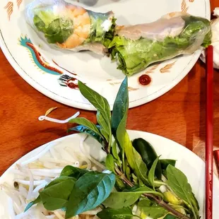A shrimp spring roll with peanut sauce. The sprouts, leaves, and lemon for the pho (pictured separately).