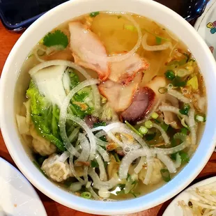 Bowl of chicken and pork pho, with wonton dumplings.