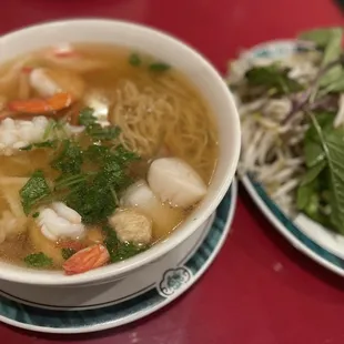 a bowl of soup and a plate of salad