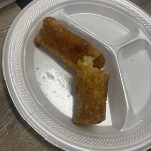 a half eaten piece of food on a paper plate