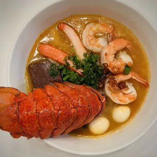 Bánh Canh Cua. 
Homemade thick rice noodles soup served with crab and shrimp. Add lobster tail