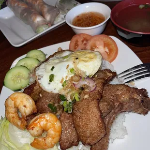 a plate of food with rice, meat, shrimp, and vegetables
