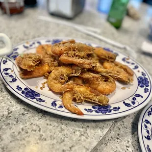 two plates of fried shrimp on a table