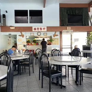 the inside of a restaurant with tables and chairs