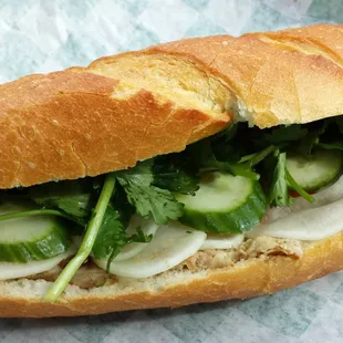 pork chop sandwich with pate spread, sweet carrots/white radish, cucumber, fresh cilantro