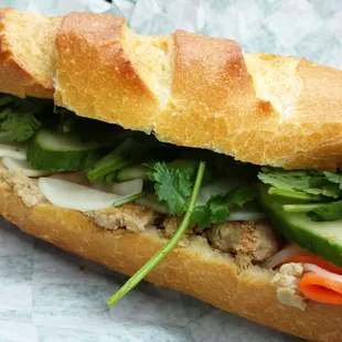 pork chop sandwich with pate spread, sweet carrots/white radish, cucumber, fresh cilantro