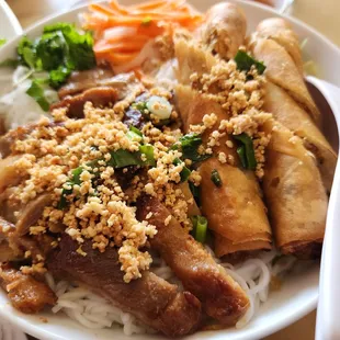 a bowl of noodles with meat and vegetables
