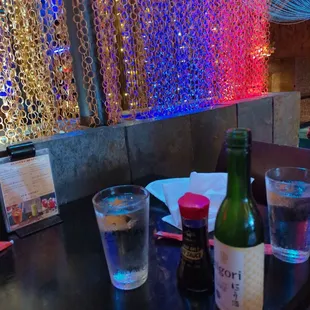 a bottle of sake and a glass of water