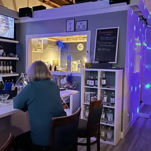 a woman sitting at a bar