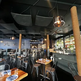 the interior of a restaurant with tables and chairs