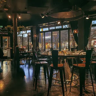 the interior of a restaurant with tables and chairs