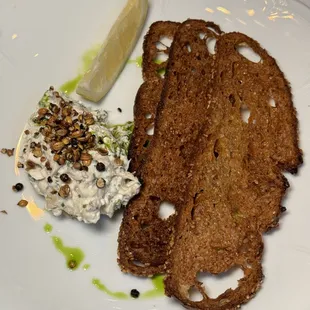 a plate of food with bread and a slice of lemon