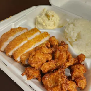 chicken, rice, and mashed potatoes in a styrofoam container