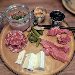 Charcuterie board with prosciutto, salami, duck paté and truffle brie