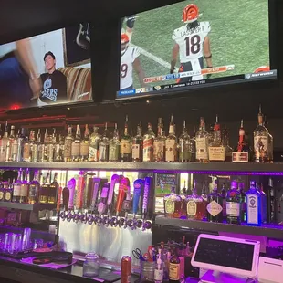 a bar with a lot of bottles of alcohol