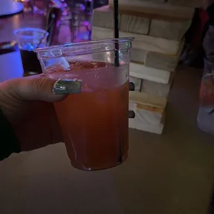 a person holding a drink