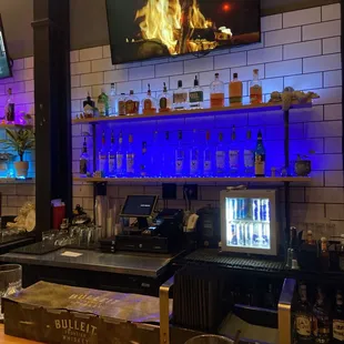 a bar with a television on the wall