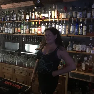 a woman standing in front of a bar