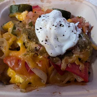 Eggs, potatoes, cheese, veggies, salsa, sour cream.