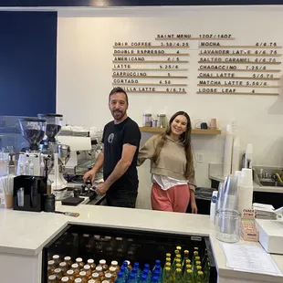 a man and a woman standing behind the counter