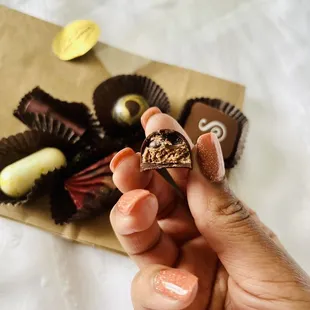  hand holding a piece of chocolate