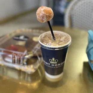 a cup of coffee and a donut on a stick