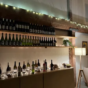 a wine bar with bottles of wine on the shelves