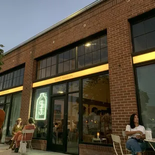 people sitting outside of a restaurant
