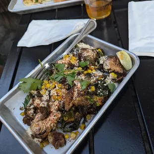 Elotes brussel sprouts - fried brussel sprouts with creamy elotes sauce, cotija cheese, roasted corn, tajin and cilantro.