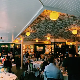 a restaurant with tables and people eating