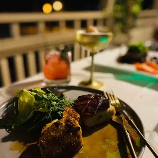 a plate of food and a glass of wine
