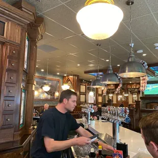 a bartender serving customers