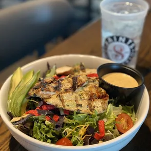 a bowl of salad and a drink