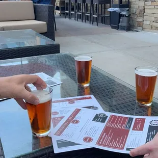a person handing a drink to another person