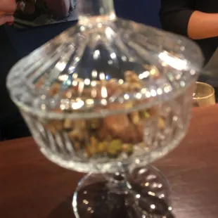 a glass bowl filled with nuts